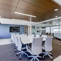 Modern conference room with sleek decor, glass walls, and sophisticated audio-visual tools.