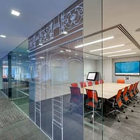 Conference room with a wall-mounted Crestron scheduling interface.