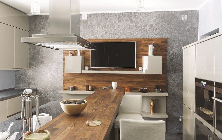 A kitchen space featuring a mounted TV screen and ceiling lighting fixtures.